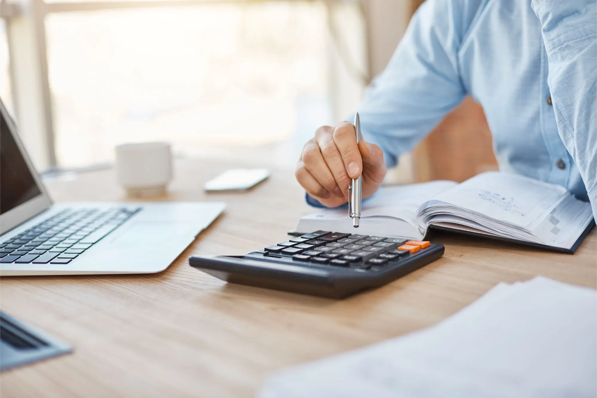 A Man Sitting at The Table Thinking and Calculating Moving Costs