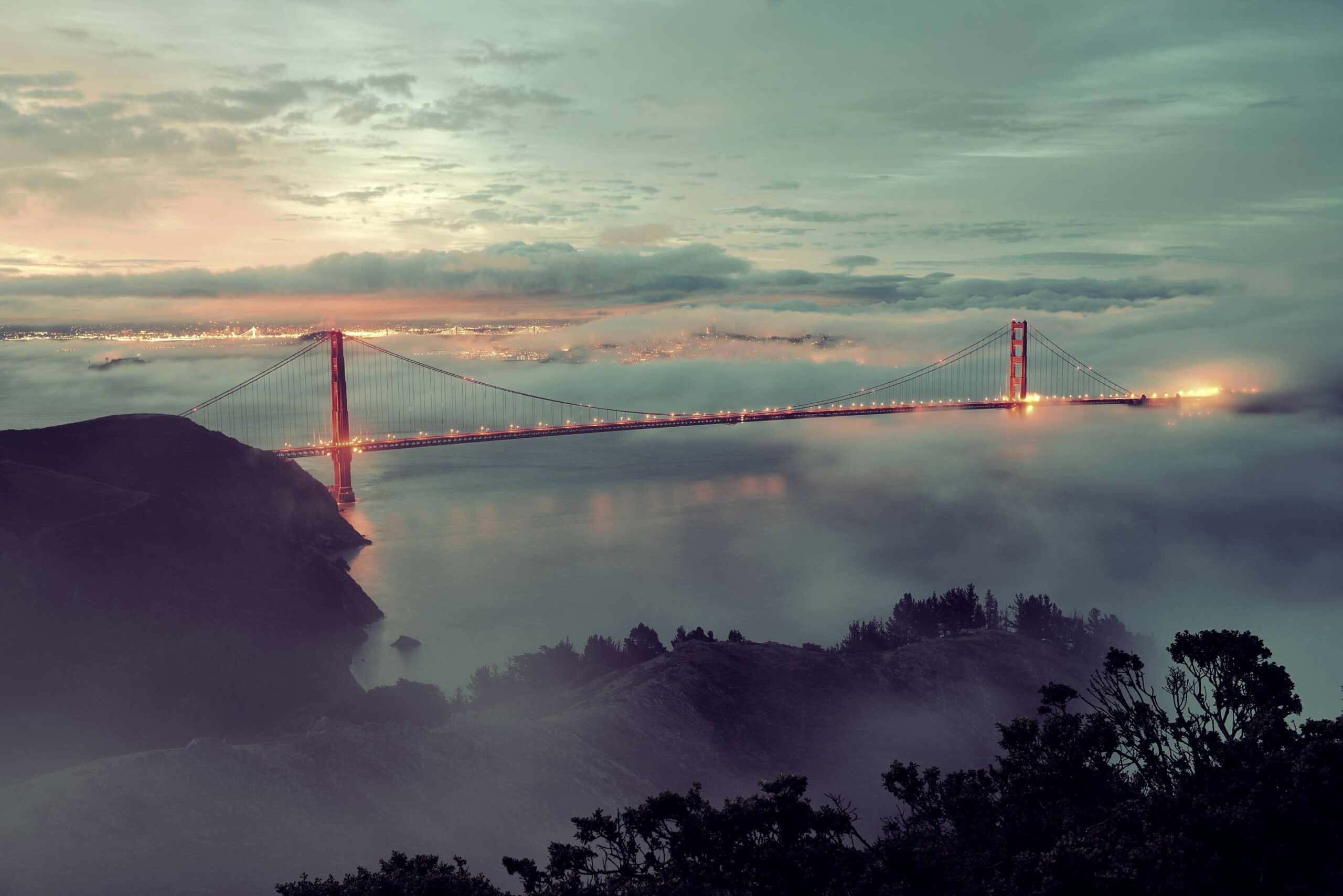 Golden Gate Bridge On a Foggy Evening With San Francisco in the Background