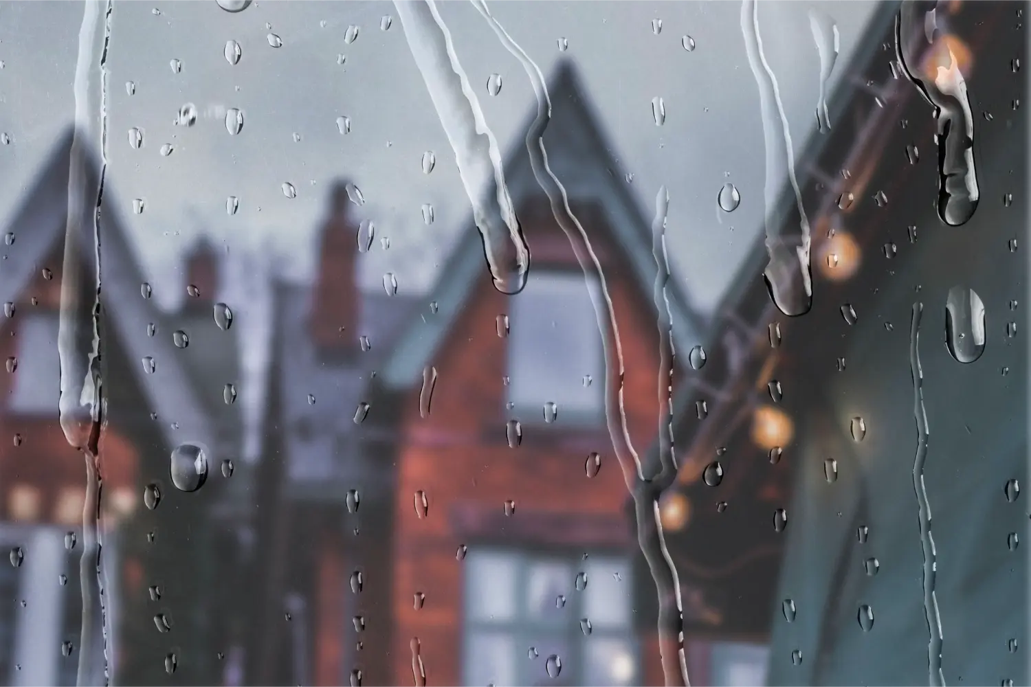 Window Rain Drop Close-up with the House in the Background