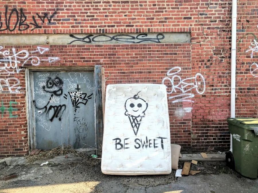 Old Mattress Leaned on Graffiti Tagged Wall in NYC