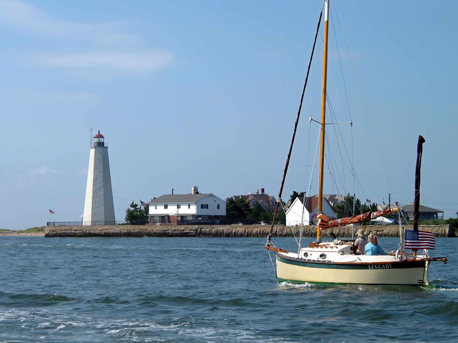 A Sailboat on the Sea Near the Lighthouse in Connecticut