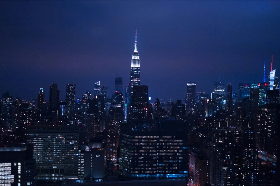 Night photo of New York City with the Empire State Building in the Background