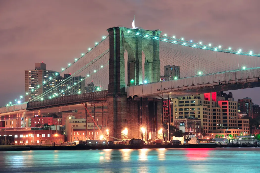 Brooklyn Bridge at Night Surrounded by City Lights