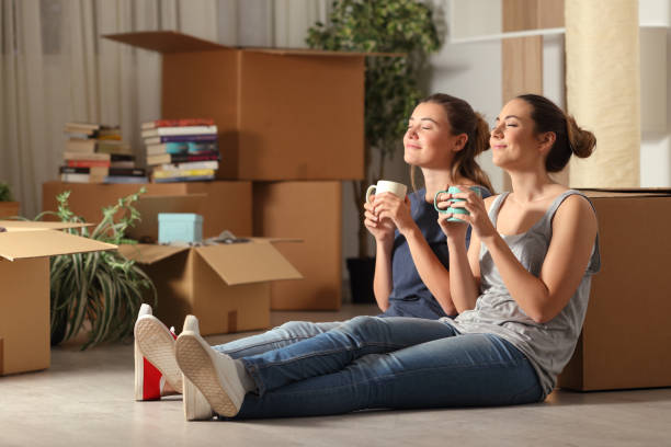 Happy Roommates Having a Coffee In Their New Apartment