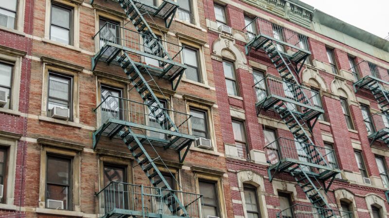 New York City Red Brick Apartment Building with Fire Escape Ladders