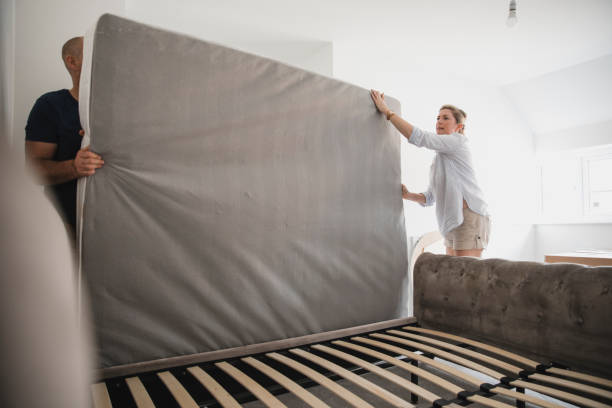 Mature Couple Preparing to Prepare Mattress for Moving