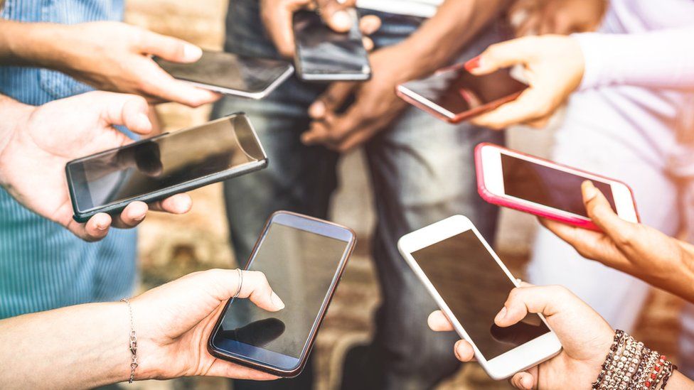 Group of People Holding Their Smartphones