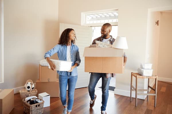 A Smiling Afro American Couple Walking into Their New Home