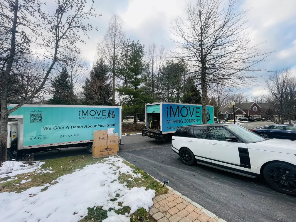 Two iMOVE NYC Trucks in Front of a Driveway for State to Sate Moving Services